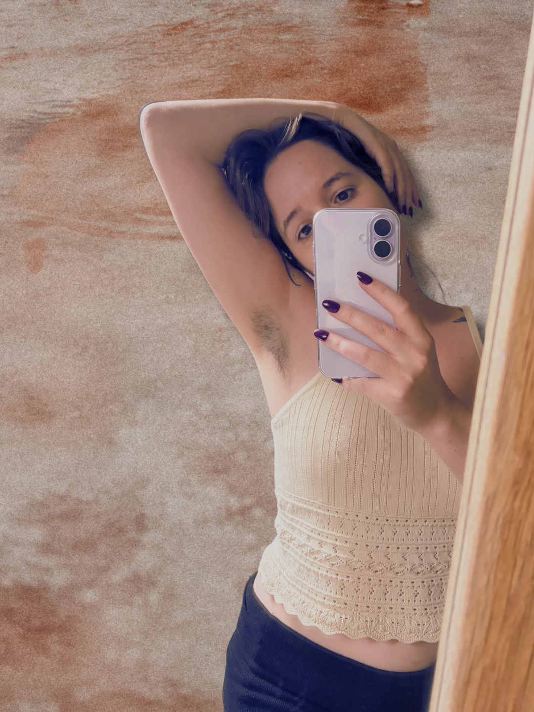 Mirror selfie with arm raised, showing dark armpit hair